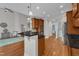 Modern kitchen featuring wood cabinets, granite counters, stainless steel appliances, and breakfast bar at 500 Chandler Grant Dr, Cary, NC 27519