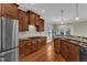 Kitchen featuring wood cabinets, granite countertops, stainless steel appliances, and ample counter space at 500 Chandler Grant Dr, Cary, NC 27519