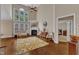 Open living room featuring a fireplace, large windows, and soaring ceilings at 500 Chandler Grant Dr, Cary, NC 27519