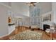 Open-concept living room with fireplace, high ceilings, hardwood floors, and kitchen access at 500 Chandler Grant Dr, Cary, NC 27519