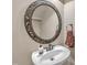 The stylish powder room features a pedestal sink with a decorative mirror and modern fixtures at 500 Chandler Grant Dr, Cary, NC 27519