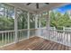 This screened porch offers outdoor living with wood flooring and nature views through large windows at 500 Chandler Grant Dr, Cary, NC 27519
