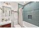 Bathroom featuring turquoise tiled walls, a shower-tub combination, and modern fixtures at 508 Bolin Creek Dr, Carrboro, NC 27510