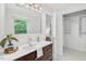 Modern bathroom featuring a vanity sink, black and white tile, and a view to a treed outdoor space at 508 Bolin Creek Dr, Carrboro, NC 27510