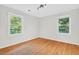 Bright bedroom featuring hardwood floors and two windows providing ample natural light at 508 Bolin Creek Dr, Carrboro, NC 27510