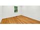 Bright bedroom featuring hardwood floors and a window with natural light at 508 Bolin Creek Dr, Carrboro, NC 27510