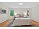 Cozy bedroom with a comfortable bed, hardwood floors, and a decorative rug at 508 Bolin Creek Dr, Carrboro, NC 27510