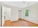 Bedroom features hardwood floors, a large window with tree views and access to both bathroom and closet at 508 Bolin Creek Dr, Carrboro, NC 27510