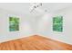Bright bedroom with hardwood floors, natural light from two windows, and neutral paint at 508 Bolin Creek Dr, Carrboro, NC 27510