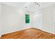 Bedroom with hardwood floors, closet, and large window providing natural light at 508 Bolin Creek Dr, Carrboro, NC 27510