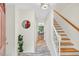 Inviting entryway featuring tile flooring, staircase, a round mirror, and a view into the dining room at 508 Bolin Creek Dr, Carrboro, NC 27510