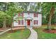 Classic two-story house with red shutters, a red front door, and a well-maintained lawn and garden at 508 Bolin Creek Dr, Carrboro, NC 27510