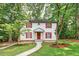 Two-story home with white siding, red shutters, landscaped yard, and a walkway leading to the front entrance at 508 Bolin Creek Dr, Carrboro, NC 27510