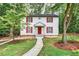 Charming two-story home featuring red shutters, a bright red door, and a landscaped front yard with a concrete walkway at 508 Bolin Creek Dr, Carrboro, NC 27510