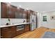 Bright kitchen features wood floors, dark cabinets, stainless appliances, and white countertops at 508 Bolin Creek Dr, Carrboro, NC 27510