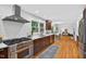 Bright, updated kitchen with stainless steel appliances, white countertops, and dark cabinetry overlooking breakfast nook at 508 Bolin Creek Dr, Carrboro, NC 27510