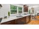 Updated kitchen features stainless steel appliances, white countertops, and double-basin sink with wooded view at 508 Bolin Creek Dr, Carrboro, NC 27510