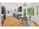 Bright kitchen features wood floors, dark cabinets, stainless appliances, and a breakfast nook with natural light at 508 Bolin Creek Dr, Carrboro, NC 27510