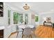 Kitchen nook features wood floors, bay window, and modern light fixture at 508 Bolin Creek Dr, Carrboro, NC 27510