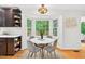 Kitchen nook features wood floors, bay window overlooking wooded yard, and modern light fixture at 508 Bolin Creek Dr, Carrboro, NC 27510