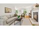 Bright living room featuring a decorative fireplace, grey sofa, and open floor plan at 508 Bolin Creek Dr, Carrboro, NC 27510