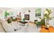 Cozy living room featuring hardwood floors, fireplace, comfortable seating, and a view to the sunroom at 508 Bolin Creek Dr, Carrboro, NC 27510