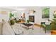 Stylish living room featuring hardwood floors, a fireplace, ample seating, and a view into a sunroom at 508 Bolin Creek Dr, Carrboro, NC 27510