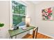 Close up on office featuring a desk, chair, decor, and a large picture window with outdoor views at 508 Bolin Creek Dr, Carrboro, NC 27510