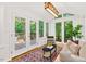 Window-lined sunroom provides natural light and a view of the backyard at 508 Bolin Creek Dr, Carrboro, NC 27510