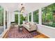 Sunroom with plenty of natural light and views of the green and wooded backyard at 508 Bolin Creek Dr, Carrboro, NC 27510