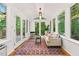 Bright sunroom boasting many windows and a view of the backyard deck at 508 Bolin Creek Dr, Carrboro, NC 27510