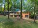Exterior view of home with deck, balcony, outbuilding, and lush backyard; a private outdoor oasis at 5257 Vann St, Raleigh, NC 27606