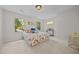 Sunlit bedroom with plush carpet, decorative bedding, and outdoor views at 5257 Vann St, Raleigh, NC 27606