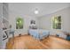 Bright bedroom featuring hardwood floors and natural light from large windows at 5257 Vann St, Raleigh, NC 27606