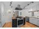 Kitchen features stainless steel appliances, a built-in oven, and a butcher block island cooktop at 5257 Vann St, Raleigh, NC 27606