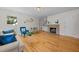 Cozy living room with a brick fireplace, hardwood floors, and natural light at 5257 Vann St, Raleigh, NC 27606