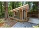 Quaint outbuilding with covered porch, providing extra space for storage or a workshop at 5257 Vann St, Raleigh, NC 27606