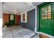 Inviting entryway with green doors, brick accents, and tiled floor at 5257 Vann St, Raleigh, NC 27606