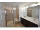 Bathroom featuring a double vanity sink, large mirror, and tiled walk-in shower at 536 Rockcastle Dr, Cary, NC 27519