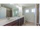 Bright bathroom features double sinks, granite countertops, and tiled shower with glass door at 536 Rockcastle Dr, Cary, NC 27519