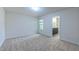 Bright bedroom with ensuite bathroom access featuring a window and plush carpet at 536 Rockcastle Dr, Cary, NC 27519