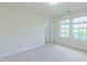 This bedroom features plush carpet, neutral color palette, and large window for natural light at 536 Rockcastle Dr, Cary, NC 27519