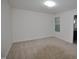 Spacious carpeted bedroom with a window and access to an ensuite bathroom at 536 Rockcastle Dr, Cary, NC 27519