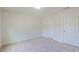 This bedroom offers neutral decor with plush carpet and convenient access to hallway and closet at 536 Rockcastle Dr, Cary, NC 27519