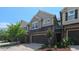 Charming townhome showcases a stone and siding exterior, complemented by a well-maintained two-car garage and front yard landscaping at 536 Rockcastle Dr, Cary, NC 27519