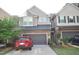 Charming townhome featuring a stone facade, neutral siding, and a convenient attached two-car garage at 536 Rockcastle Dr, Cary, NC 27519