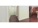 Spacious foyer with hardwood floors leading to a kitchen area with dark cabinets and stainless steel appliances at 536 Rockcastle Dr, Cary, NC 27519