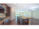 Open concept kitchen features a large island, stainless appliances, dark wood cabinets, and adjacent living area at 536 Rockcastle Dr, Cary, NC 27519
