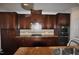 Gourmet kitchen with sleek dark wood cabinets, granite countertops, and high-end stainless steel appliances at 536 Rockcastle Dr, Cary, NC 27519