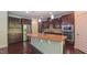 The kitchen features a large island with seating, granite countertops, a stainless-steel refrigerator, and dark cabinets at 536 Rockcastle Dr, Cary, NC 27519